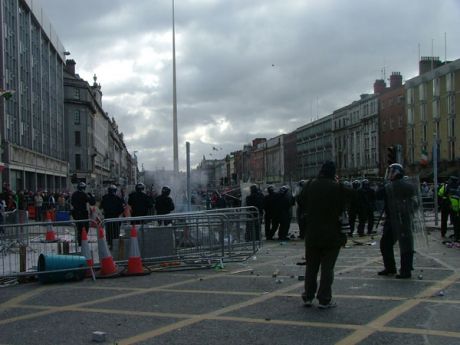 Guards Face Stiff Resistance as Showers of Projectiles Rain Down on them